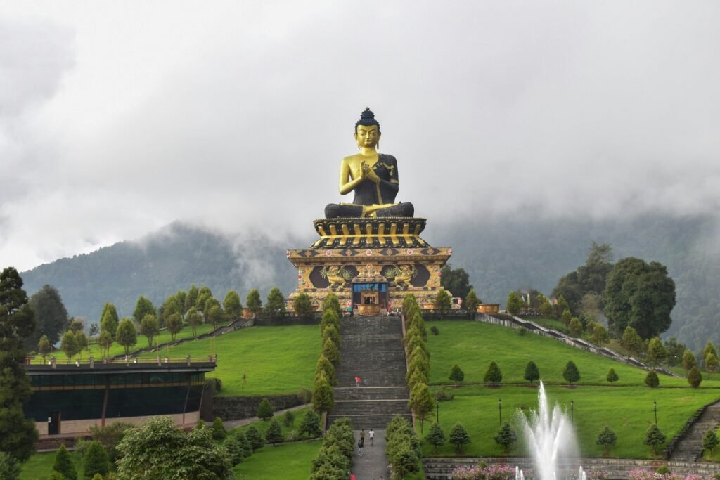 Large golden Buddha statue in landscaped gardens, Sikkim
