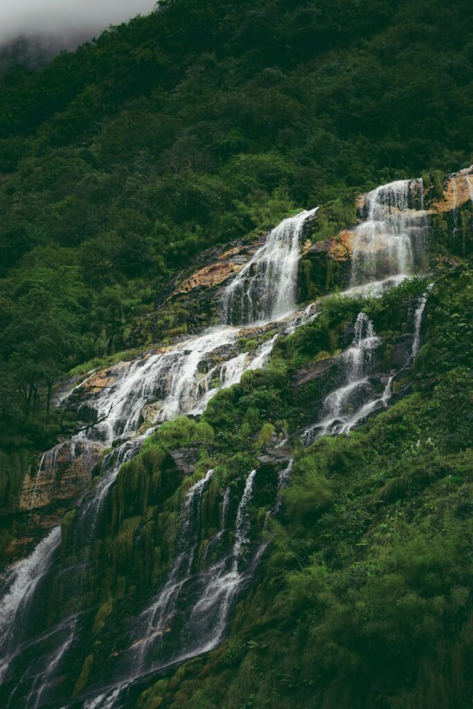 Cascading waterfall on a green hillside