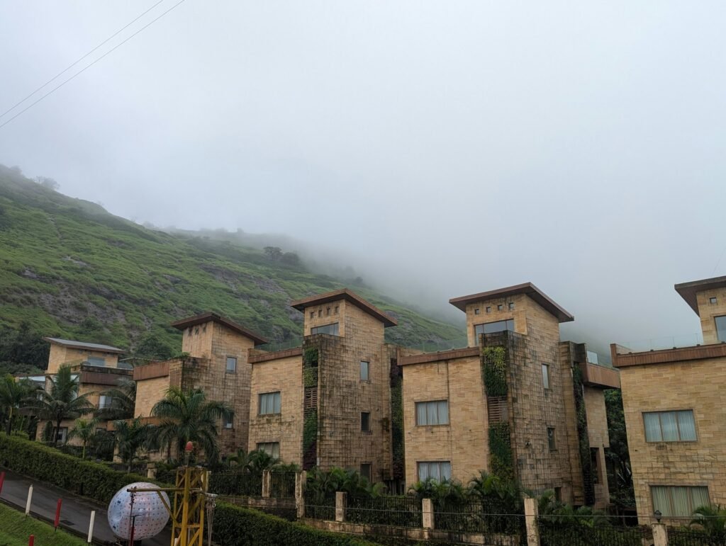 Stone resort buildings on a misty mountainside