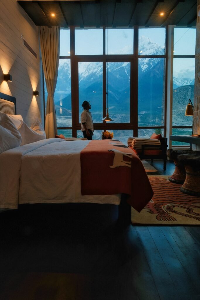 Warm hotel room with large windows over the valley