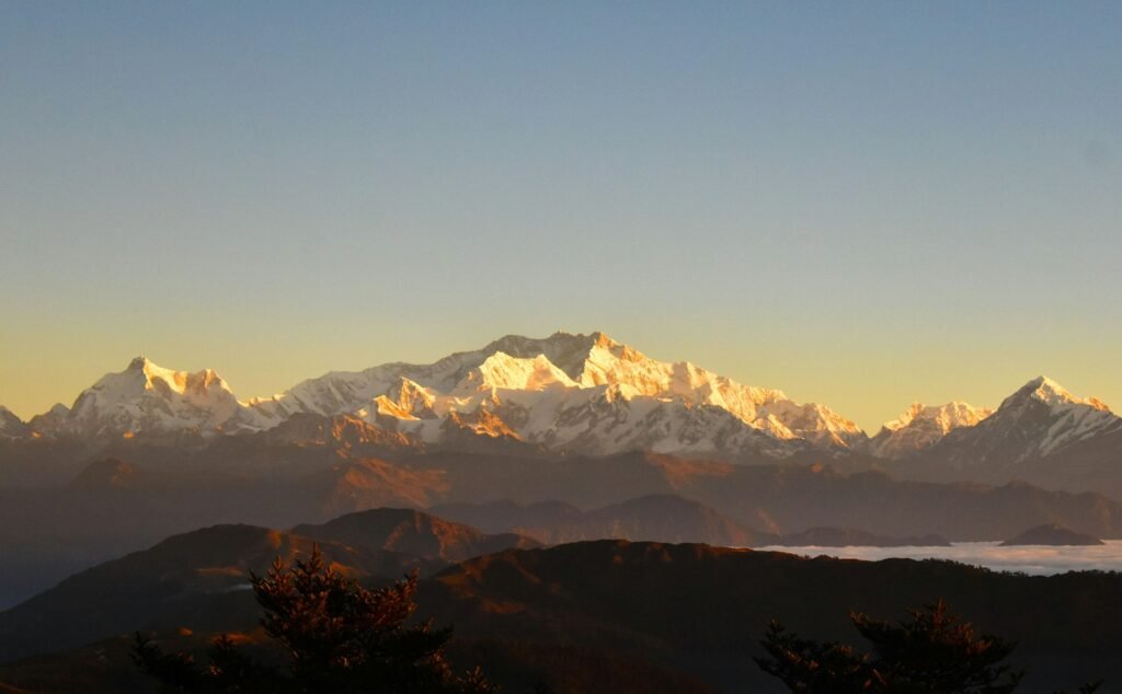 Golden morning light on the Kanchenjunga range above the valley
