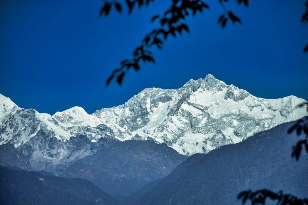 Snow-covered Kanchenjunga massif under a clear blue sky
