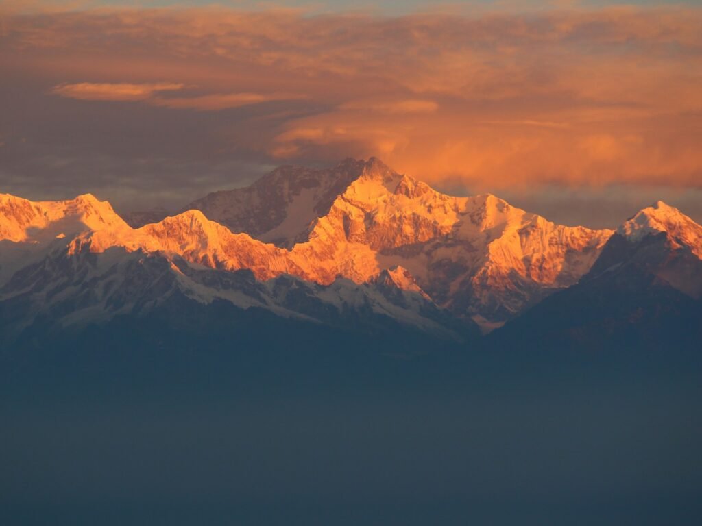 Kanchenjunga glowing orange at sunrise, seen from West Sikkim