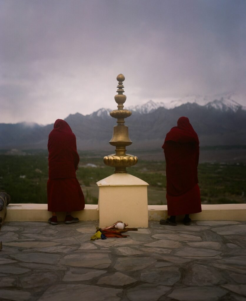 Buddhist monks at a monastery viewpoint in the Himalaya