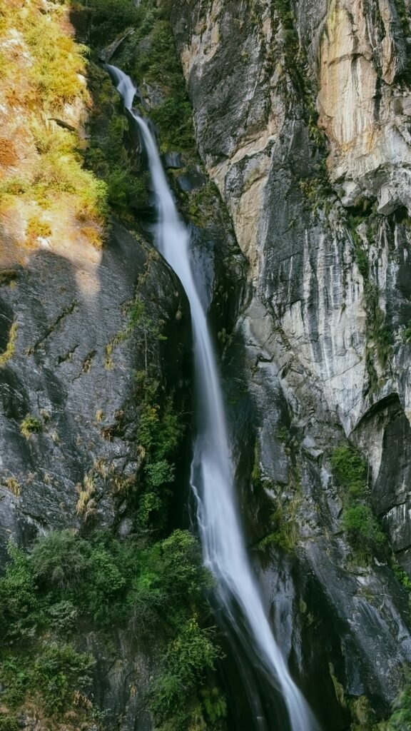 Tall waterfall falling down a rocky cliff face